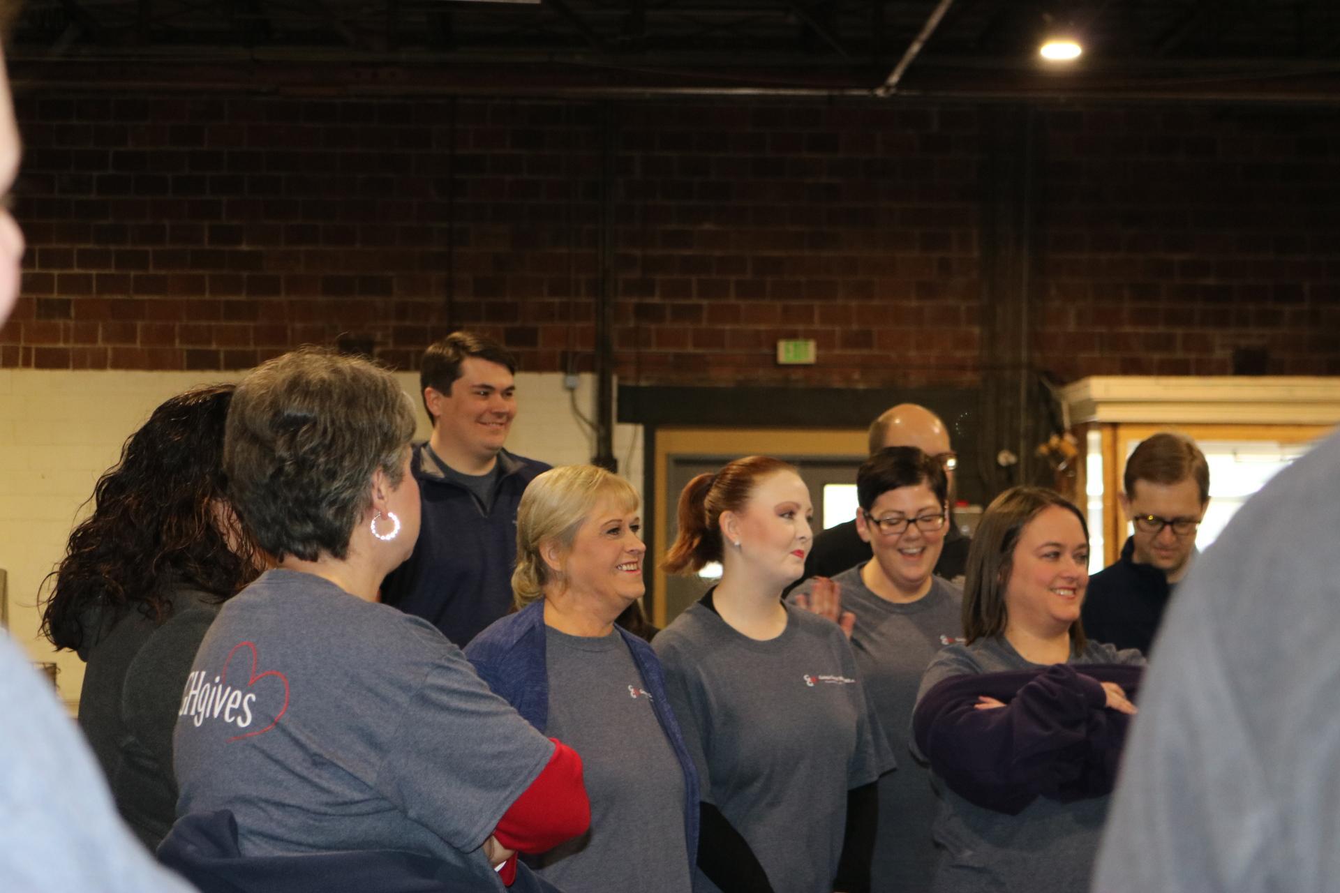 a group of people standing in front of a crowd posing for the camera