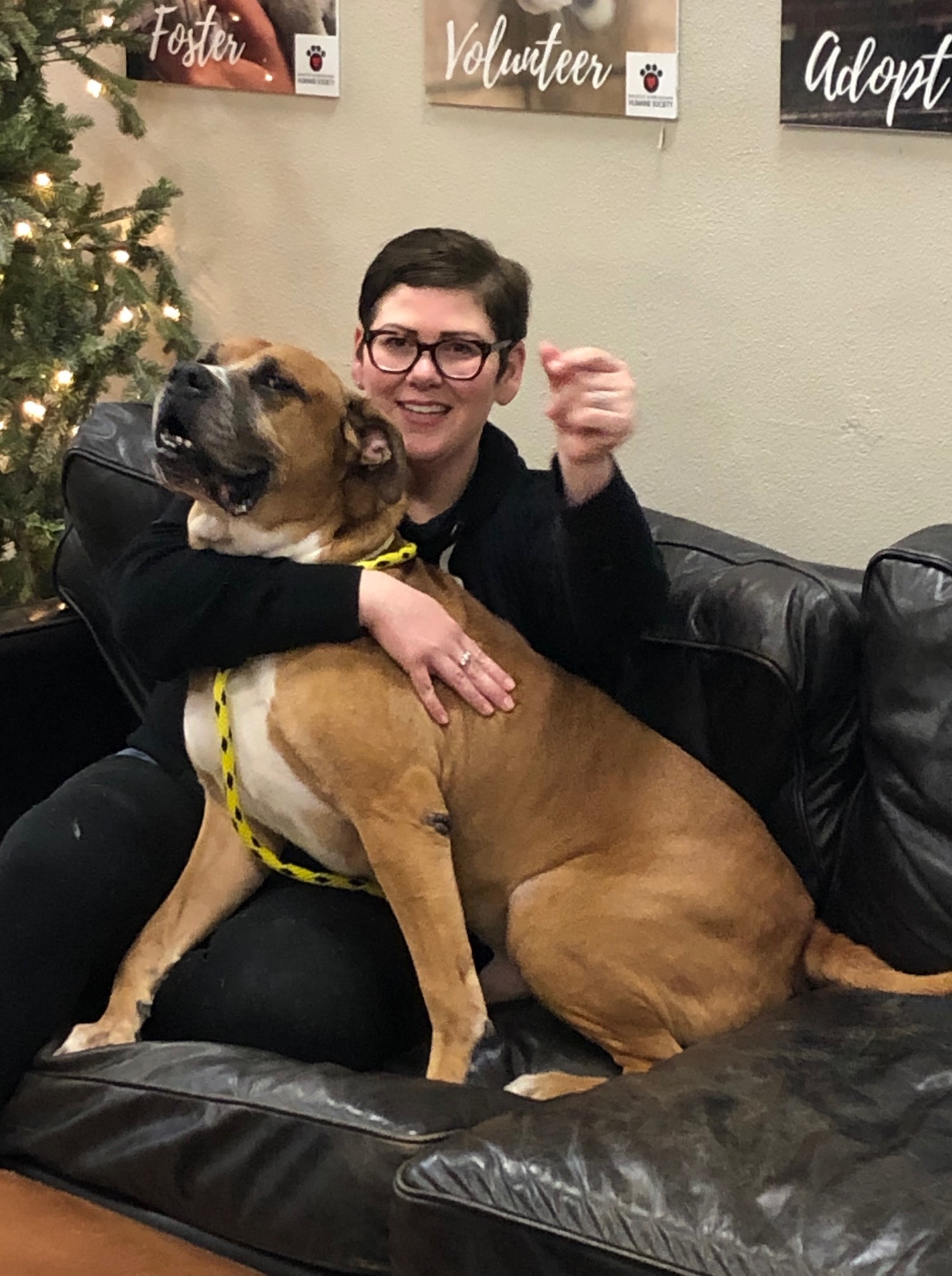 a man and woman sitting next to a dog