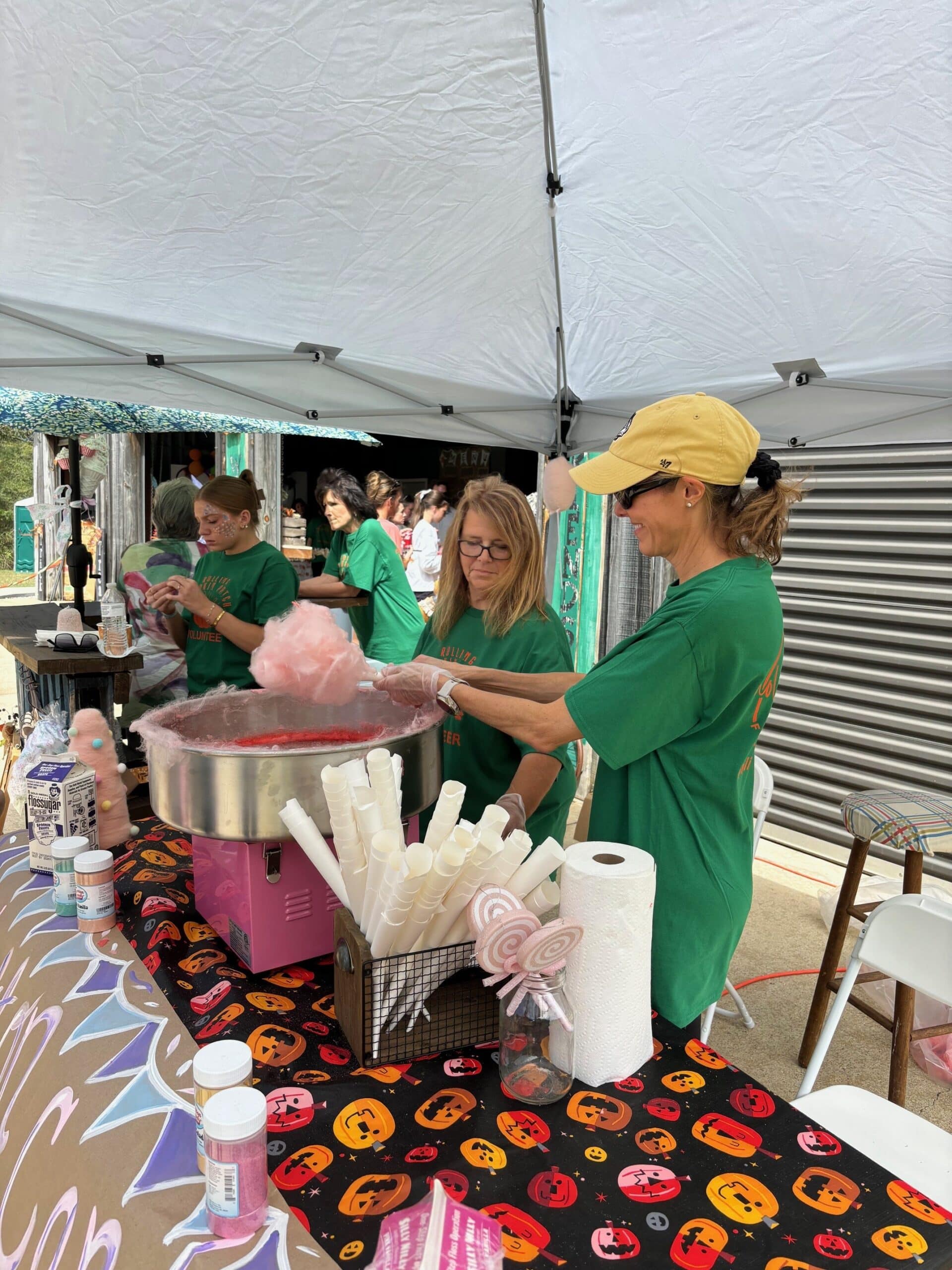 a group of people standing around a table