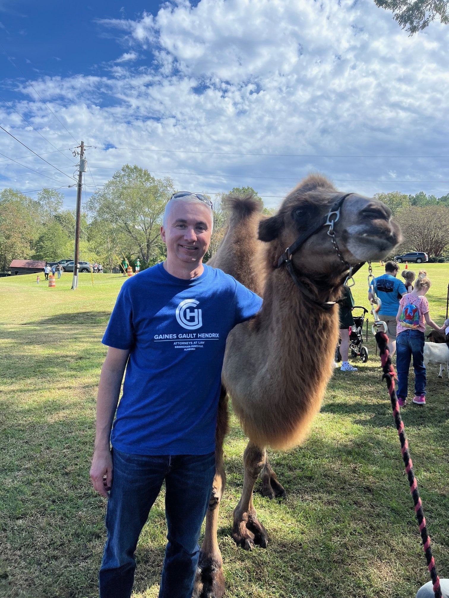 a person standing next to a llama