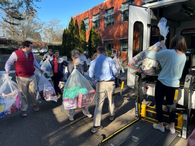 a group of people standing on a sidewalk