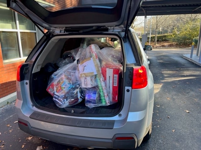 a van parked on the side of the trunk of a car