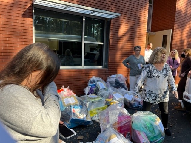 a group of people standing around a table